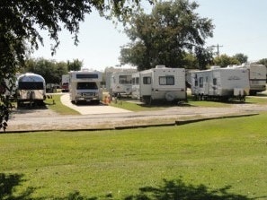 A Grassy Lawn with RV's parked in the background